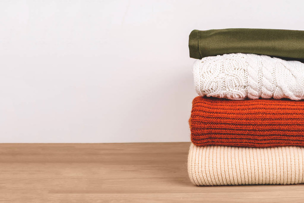 Pile of warm clothes on the table. - Foto, Imagen