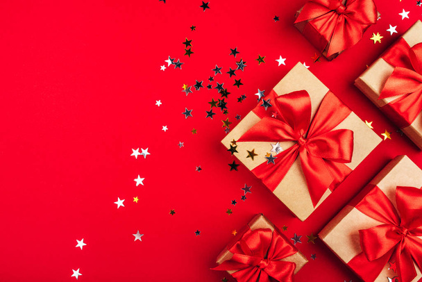 Several gift boxes with bows on a red background. - Foto, imagen