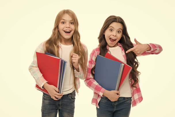 Happy to be students. School supplies concept. We love study. School stationery. Pupils carrying big textbooks to school classes. Taking extra classes. Girls with school textbooks white background - Photo, Image