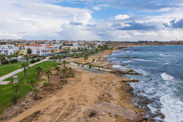Paphos embankment or promenade, Cyprus, with sandy beach, green palm trees and lawns and small houses on first coastline, aerial view from drone - Foto, Imagem