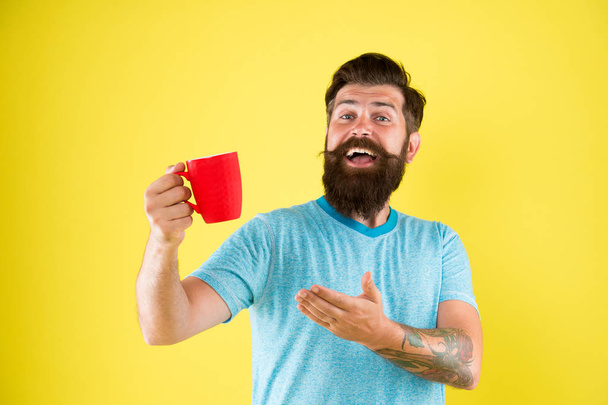 Herbal tea. Aromatic beverage. Understand value taste really great cup of coffee. Coffee shop. Bearded man satisfied drink morning coffee. Energy concept. Hipster stylish barista yellow background - Foto, Imagem
