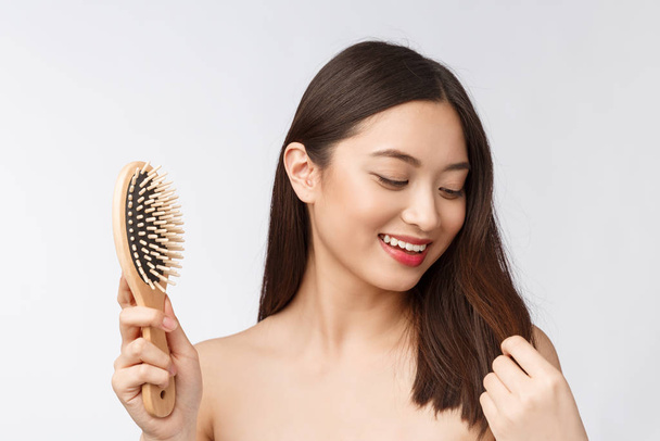 portrait of a beautiful young woman comb wonderful hair isolated on white background, asian beauty - 写真・画像