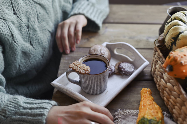 Autumn, pumpkins, hot steaming cup of coffee on a wooden table background. Seasonal, morning coffee, sunday relaxing and still life concept. Plans for the day. The girl in the frame. - Fotografie, Obrázek