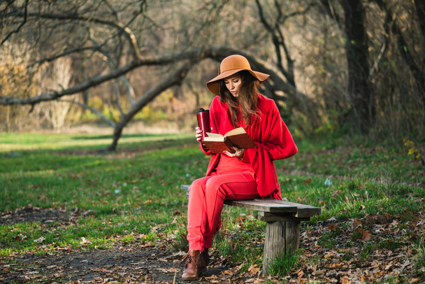 Girl on bench with thermos and book - Photo, Image
