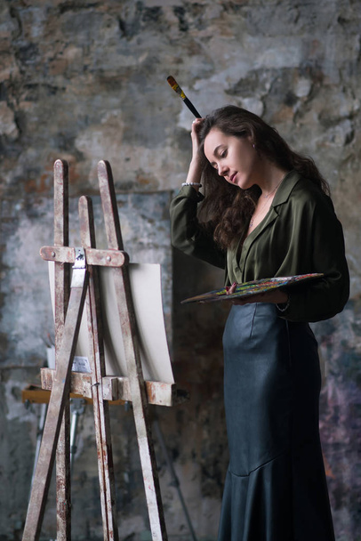 Boya fırçası ve paleti olan sanatçı kadın ressam. - Fotoğraf, Görsel
