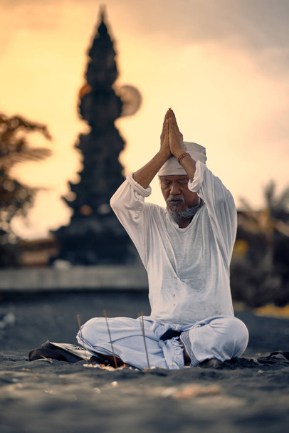 Bali, Indonesia - 2 Dec 2019: Old local balinese man in meditati - 写真・画像