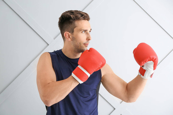 Sporty male boxer on light background - Photo, Image