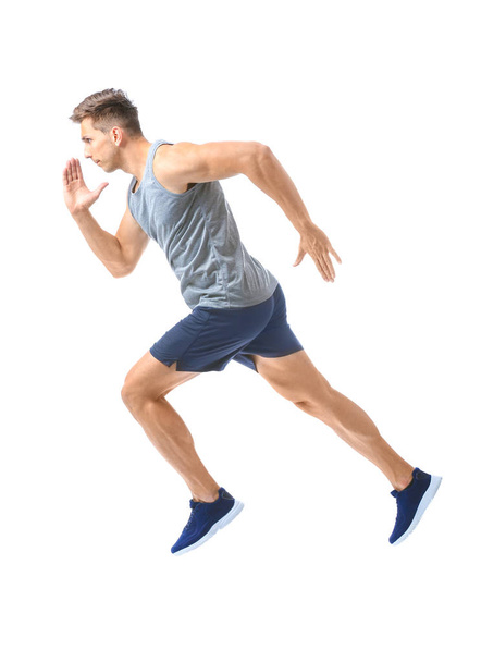 Sporty running young man on white background - Zdjęcie, obraz