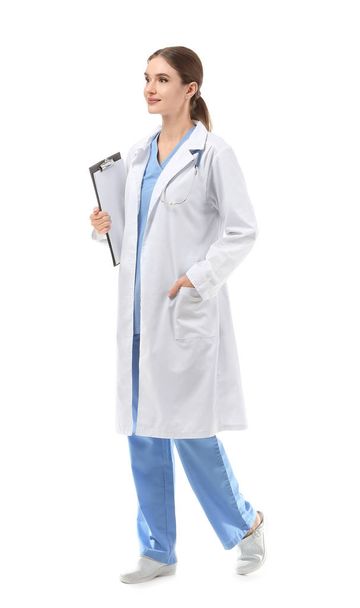 Portrait of female doctor with clipboard on white background - Foto, Bild