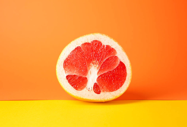 Kousek čerstvého grapefruitu na barevném pozadí - Fotografie, Obrázek