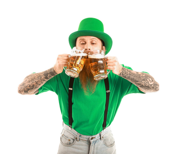 Bearded man with glasses of beer on white background. St. Patrick's Day celebration - Photo, Image