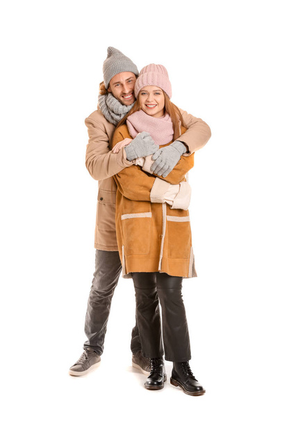 Happy couple in winter clothes on white background - Foto, imagen