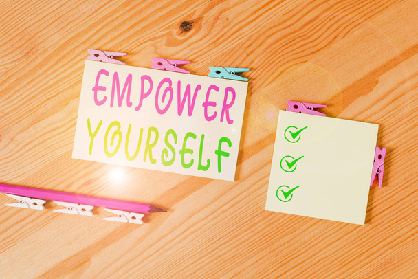 Word writing text Empower Yourself. Business concept for giving you the power to take control of your own destiny Colored clothespin papers empty reminder wooden floor background office. - Photo, Image