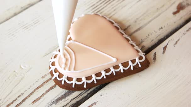 Decorating heart-shaped cookie with piping bag. - Footage, Video