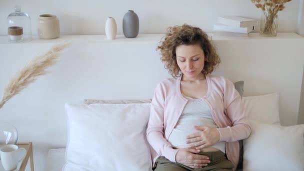 Pregnancy Concept. Pregnant Female Resting At Home In Bed. - Кадри, відео