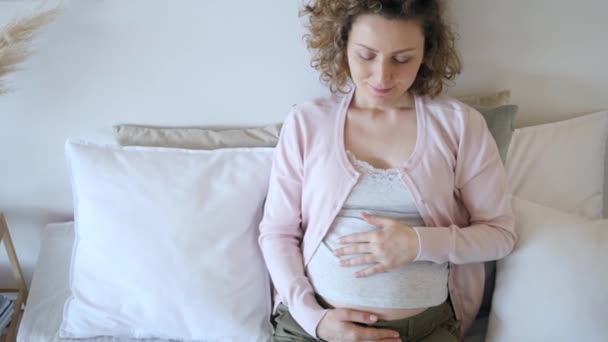 Pregnancy. Pregnant Woman Hugging Her Belly While Relaxing In Bed. - Filmati, video