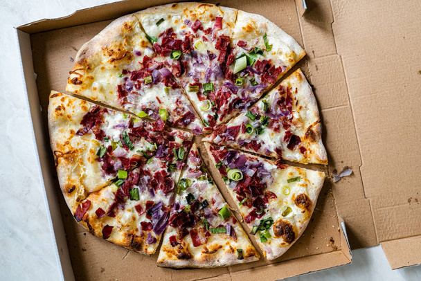 Flammkuchen Pizza Slices / Traditional Tarte Flambee with Creme Fraiche, Cream Cheese, Bacon and Red Onions in Box. - Photo, Image