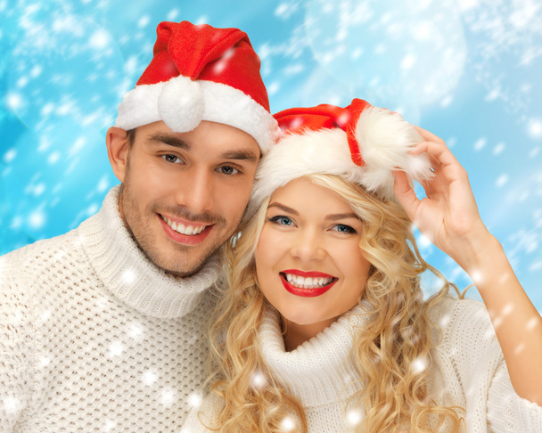 Family couple in sweaters and santa's hats - Foto, Bild