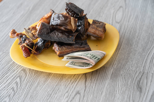 Nigerian dried roasted fish with Naira notes - Photo, Image
