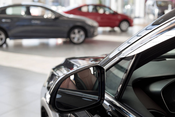 New cars at dealer showroom. Themed blur background with bokeh effect. Car auto dealership. - Φωτογραφία, εικόνα