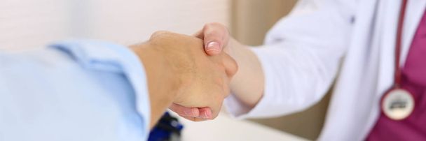 Female medicine doctor shake hand as hello - Foto, imagen