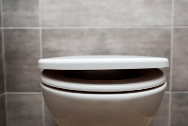 close up view of ceramic clean toilet bowl with lid in modern restroom  - Фото, изображение