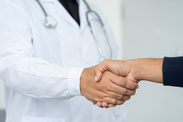 Close up of doctor expressing his congratulations to the patient for illness recovery and before checking hospital. Doctor is congratulations the patient. - Photo, Image