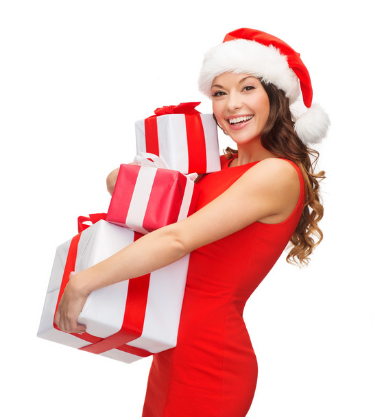 Woman in santa helper hat with many gift boxes - Zdjęcie, obraz