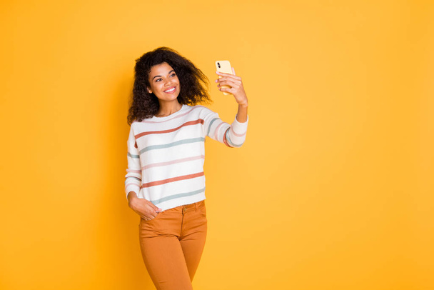 Portrait of her she nice attractive lovely cheerful wavy-haired girl using digital gadget taking making selfie sharing smm post isolated over bright vivid shine vibrant yellow color background - Foto, Imagem
