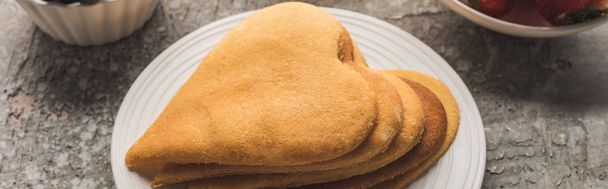 delicious heart shaped pancakes on plate on grey concrete surface, panoramic shot - Fotó, kép