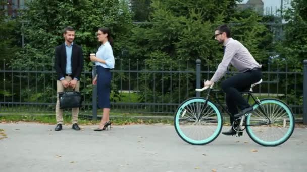 Guy in formal clothing riding bike in city ejoying eco transport and exercising - Filmagem, Vídeo