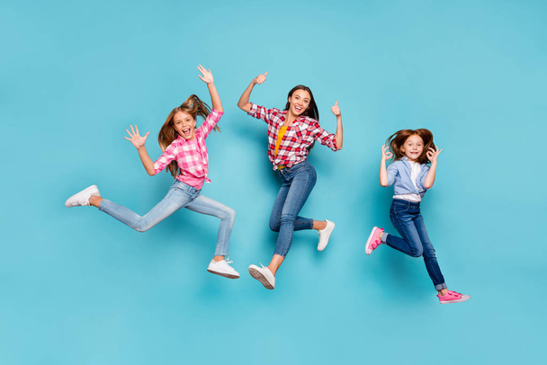 Full length body size photo of white rejoicing overjoyed winning family having given feedback on something wearing jeans denim while isolated with blue background - Foto, imagen