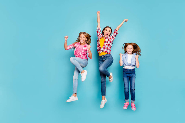 Full length body size photo of rejoicing casual white family having obviously won something wearing jeans denim while isolated with blue background - Photo, image