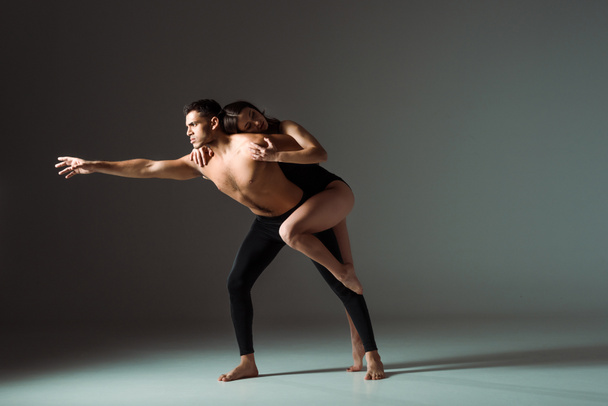sexy dancers dancing contemporary on dark background with copy space  - 写真・画像