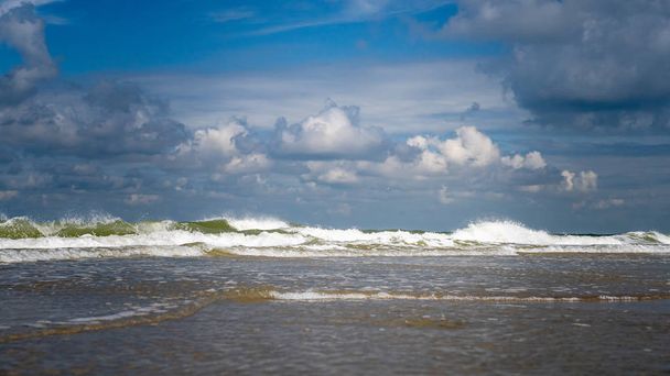 Splashing waves on the coast of the Netherlands with white foam  - Photo, Image