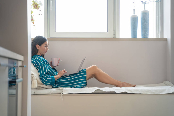 Woman using modern laptop at home stock photo - Valokuva, kuva