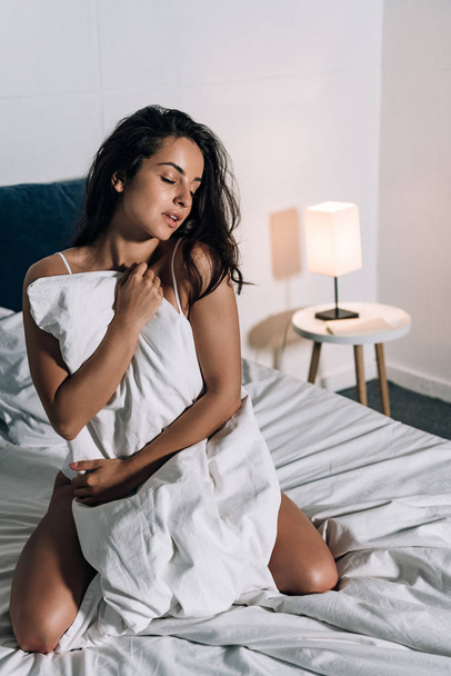 seductive, dreamy girl wrapping in blanket in bedroom - Foto, imagen