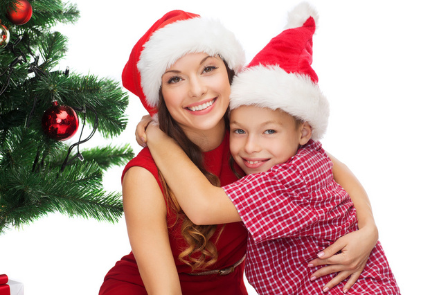 Happy mother and child boy in santa helper hats - Photo, image