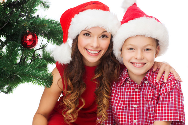 Happy mother and child boy in santa helper hats - Foto, Imagem
