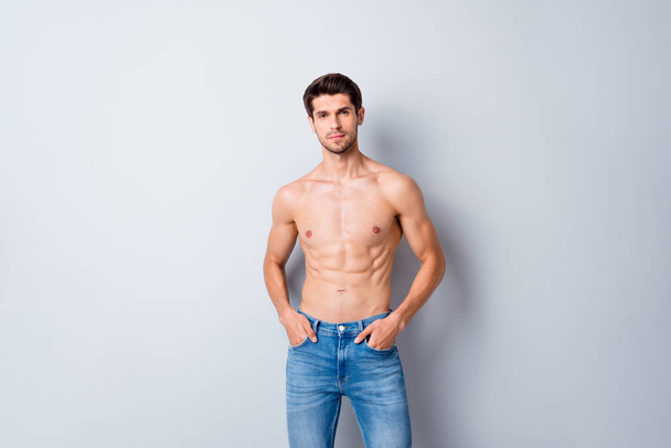 Portrait of his he nice attractive content cool fashionable muscular shirtless guy perfect figure form shape wearing jeans isolated over light white gray color pastel background - Foto, Bild