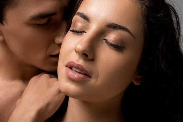 hermosa pareja joven sensual abrazando con los ojos cerrados aislados en gris
 - Foto, imagen