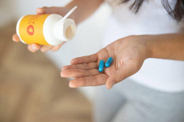 Vitamin tablets lying on a woman palm - Foto, Imagen