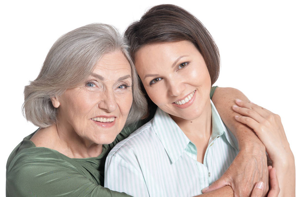 close up portrait of mother and her adult daughter  isolated on white  - Photo, Image