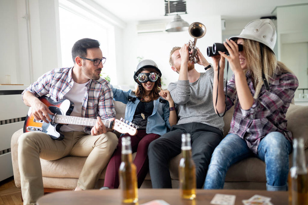 Cheerful group of friends having party together and playing instruments - Fotoğraf, Görsel