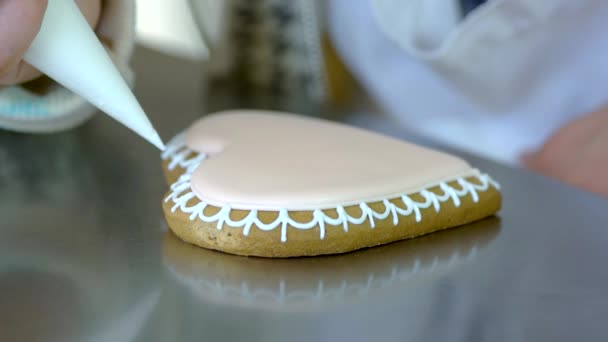 Decoration of gingerbread cookie with pastry syringe. - Footage, Video