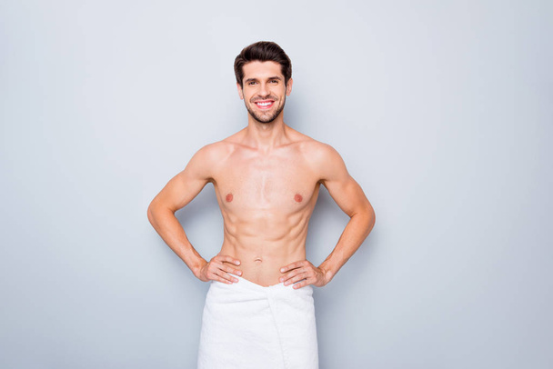 Portrait of positive guy having spa skincare procedure enjoy smooth flawless effect stand in bathroom with white towel isolated over grey color background - Foto, Bild