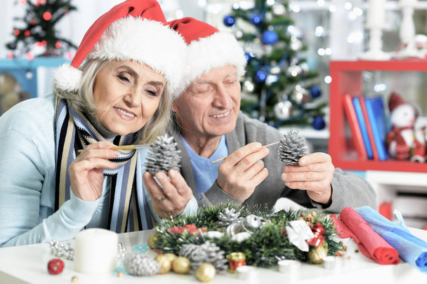 Portrait of happy senior couple preparing for Christmas at home  - Fotoğraf, Görsel