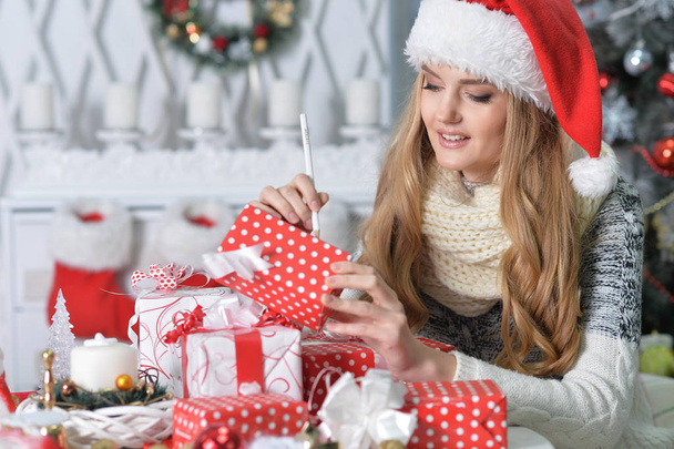 young woman in Santa hat with present boxes - Photo, Image