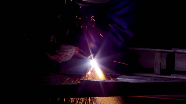 Worker in gloves cutting sheet metal with acetylene or oxygen torch. - Photo, Image