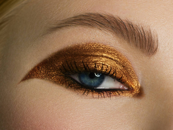 Beauty close-up portrait of beautiful young woman model face with clean skin. Wellness, skincare and bright black liner and gold make-up. extremaly long eyelashes - Photo, image